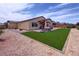Spacious backyard with artificial turf, patio, and a built-in spa at 5528 Eleganza Ave, Pahrump, NV 89061