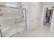 Modern bathroom featuring a glass enclosed shower with white tiles and a view of a walk-in closet at 5528 Eleganza Ave, Pahrump, NV 89061