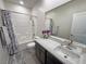 Bathroom with a shower-tub combo, a large mirror, and a single sink vanity at 5528 Eleganza Ave, Pahrump, NV 89061