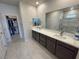 Modern bathroom featuring double sinks, a large mirror, and a walk-in closet, providing ample storage space at 5528 Eleganza Ave, Pahrump, NV 89061