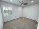Empty bedroom featuring a ceiling fan, neutral carpet, and a window with shutters at 5528 Eleganza Ave, Pahrump, NV 89061
