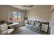 Comfortable bedroom features a sofa, a desk, and a bright window with shutters at 5528 Eleganza Ave, Pahrump, NV 89061