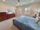 Bedroom featuring an ensuite bathroom, bright natural light, carpet, and classic decor with a ceiling fan at 5528 Eleganza Ave, Pahrump, NV 89061