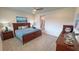 Well-lit bedroom featuring a ceiling fan, carpet, and a coordinating decor, creating a calming atmosphere at 5528 Eleganza Ave, Pahrump, NV 89061