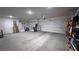 Spacious three car garage with ample room for vehicles and storage, featuring bright lighting at 5528 Eleganza Ave, Pahrump, NV 89061