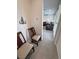 Hallway view into a living room featuring seating, tile floors, and a decorative metal tree wall hanging at 5528 Eleganza Ave, Pahrump, NV 89061