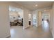 Bright hallway with tile flooring, leading to various rooms in the house with an open concept at 5528 Eleganza Ave, Pahrump, NV 89061