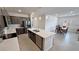 Modern kitchen featuring stainless steel appliances, a kitchen island and an adjacent dining area at 5528 Eleganza Ave, Pahrump, NV 89061