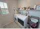 Organized laundry room with modern washer and dryer, open shelving, and stylish patterned flooring at 5528 Eleganza Ave, Pahrump, NV 89061
