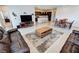 Open concept living space with tile floors, modern furnishings, and adjacent dining and kitchen areas at 5528 Eleganza Ave, Pahrump, NV 89061