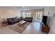 Spacious living room with ample seating, large windows, and a modern ceiling fan for comfort at 5528 Eleganza Ave, Pahrump, NV 89061