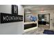 Modern lobby featuring marble floors, sleek reception desk, and signage for Mountain Falls at 5528 Eleganza Ave, Pahrump, NV 89061
