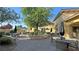 Charming outdoor patio with ample seating, shade umbrellas, and beautiful landscaping at 5528 Eleganza Ave, Pahrump, NV 89061
