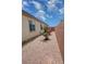 Side yard with desert landscaping and brick wall at 5528 Eleganza Ave, Pahrump, NV 89061