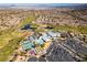 Expansive aerial shot of golf course community including tennis courts, a pool, and manicured lawns with city views at 561 Carmel Valley St, Henderson, NV 89012
