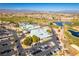 Stunning aerial view of a golf course community featuring lush landscaping, lakes, and a well-appointed clubhouse at 561 Carmel Valley St, Henderson, NV 89012