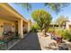Enjoy the serene backyard with a covered patio, lush landscaping, and charming water feature at 561 Carmel Valley St, Henderson, NV 89012