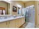 Bright bathroom featuring a walk-in shower, dual sinks, and ample counter space at 561 Carmel Valley St, Henderson, NV 89012