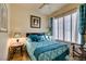 Charming bedroom with hardwood floors, a comfortable bed, and bright natural light at 561 Carmel Valley St, Henderson, NV 89012