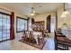 Elegant dining area with a ceiling fan, a large window and access to the backyard at 561 Carmel Valley St, Henderson, NV 89012