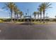 Beautiful exterior of the community center with meticulously maintained landscaping and palm tree lined entrance at 561 Carmel Valley St, Henderson, NV 89012