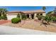 Charming single-story home with desert landscaping and a brick walkway leading to the front door at 561 Carmel Valley St, Henderson, NV 89012