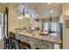 Spacious kitchen boasts an island, breakfast bar, and modern pendant lighting for an inviting cooking space at 561 Carmel Valley St, Henderson, NV 89012