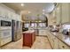 Well-lit kitchen with stainless steel appliances, tile floors, and center island at 561 Carmel Valley St, Henderson, NV 89012