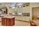 Bright kitchen featuring custom cabinets, central island, and tile floors at 561 Carmel Valley St, Henderson, NV 89012