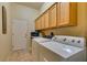 Laundry room featuring washer, dryer, and storage cabinets at 561 Carmel Valley St, Henderson, NV 89012