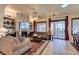 Inviting living room with a stone fireplace, comfortable seating, and sliding door access to the patio at 561 Carmel Valley St, Henderson, NV 89012