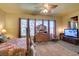 Bright main bedroom featuring carpet, ceiling fan, and large windows at 561 Carmel Valley St, Henderson, NV 89012