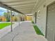 Covered back patio area featuring a manicured artificial lawn and decorative gravel at 604 N Minnesota St, Las Vegas, NV 89107
