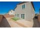 View of the home's backyard and patio area, enclosed with a brick privacy wall at 6148 Vista Teal Ln, Las Vegas, NV 89115
