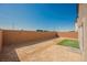 Spacious backyard area featuring a brick wall, a small patch of green grass, and ample space for outdoor activities at 6148 Vista Teal Ln, Las Vegas, NV 89115