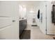 Modern bathroom featuring double sinks, gray cabinets, large mirror, and glass door shower at 6148 Vista Teal Ln, Las Vegas, NV 89115