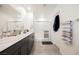 Bathroom with double sinks, granite countertops, gray cabinets, and a glass shower enclosure at 6148 Vista Teal Ln, Las Vegas, NV 89115