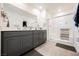 Bathroom showcasing double vanity with gray cabinets and a well-lit glass-enclosed shower at 6148 Vista Teal Ln, Las Vegas, NV 89115