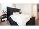 Bedroom with a large, black upholstered headboard and white comforter on the bed at 6148 Vista Teal Ln, Las Vegas, NV 89115