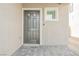 Close-up of front entry with a gray door and stone-paved porch at 6148 Vista Teal Ln, Las Vegas, NV 89115