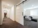 A hallway with a bedroom at the end and a sliding barn door entry at 6148 Vista Teal Ln, Las Vegas, NV 89115