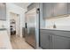 This kitchen features stainless steel refrigerator, gray cabinets, and a pantry at 6148 Vista Teal Ln, Las Vegas, NV 89115