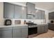 This kitchen showcases gray cabinets, stainless steel appliances, and stylish countertops at 6148 Vista Teal Ln, Las Vegas, NV 89115