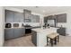 Modern kitchen featuring gray cabinets, stainless steel appliances, and a center island at 6148 Vista Teal Ln, Las Vegas, NV 89115