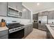 Gray cabinets and stainless steel appliances enhance this modern kitchen design at 6148 Vista Teal Ln, Las Vegas, NV 89115