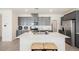 Bright kitchen featuring an island with quartz countertop, stainless steel appliances, and gray cabinets at 6148 Vista Teal Ln, Las Vegas, NV 89115
