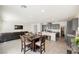 Spacious, open-concept living space with a modern kitchen, dining area, and inviting living room at 6148 Vista Teal Ln, Las Vegas, NV 89115
