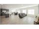 Open-concept living room with tile flooring, ample natural light, and stylish furniture at 6148 Vista Teal Ln, Las Vegas, NV 89115