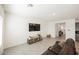 Inviting living room with neutral tones, tile flooring, and a TV at 6148 Vista Teal Ln, Las Vegas, NV 89115