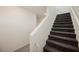 Carpeted staircase with gray carpet, white walls, and a handrail at 6148 Vista Teal Ln, Las Vegas, NV 89115
